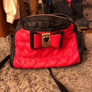Black and pink purse with a large bow